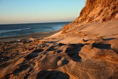 View of sandy beach against clear sky