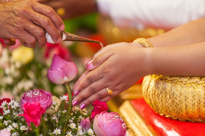 Close-up of hands holding flowers