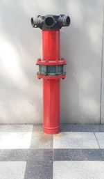 Red fire hydrant on footpath