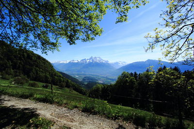 Scenic view of trees and mountains against sky
