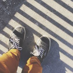 Low section of person standing on road