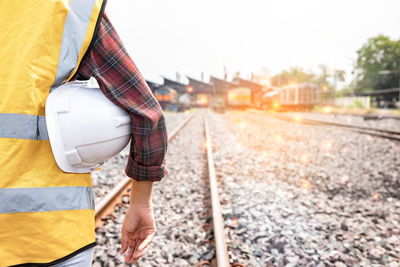 Low section of man standing on road