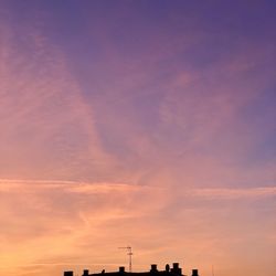 Low angle view of silhouette buildings against sky during sunset
