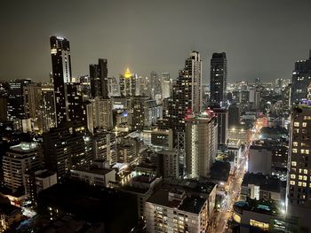 High angle view of city lit up at night