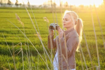 Portrait of young woman standing in farm