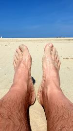 Low section of man legs on sand