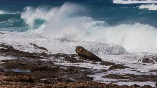 Waves splashing on rocks at shore