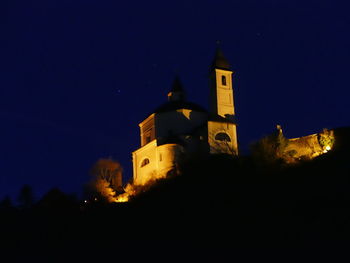 Low angle view of illuminated building against sky at night