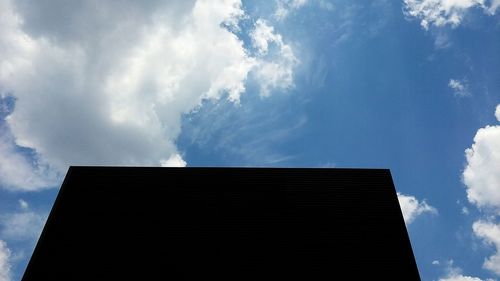 Low angle view of building against cloudy sky