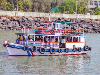 People on boat against river