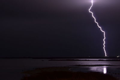 Scenic view of sea against sky at night