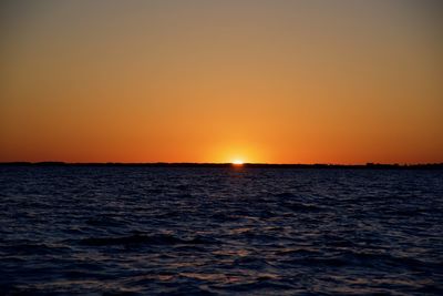 Scenic view of sea against clear sky during sunset