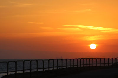 Scenic view of sea against romantic sky at sunset