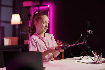 Portrait of young woman using laptop on table