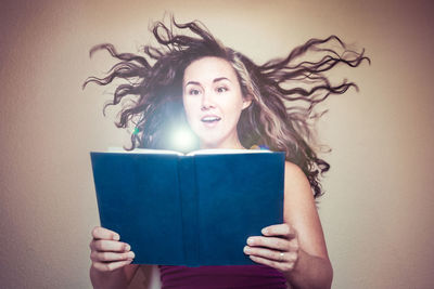 Woman reading book with against white background