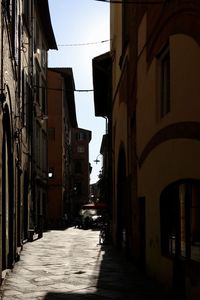 Narrow street amidst buildings against sky