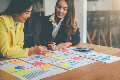 Colleagues working over graph in office