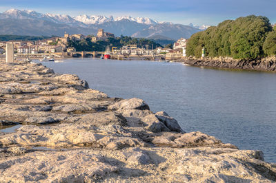 Scenic view of sea and buildings against sky