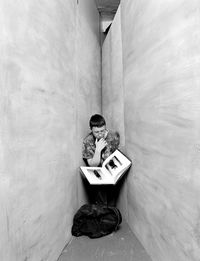Man with book amidst walls