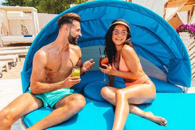Low angle view of woman sitting in swimming pool