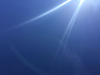 Low angle view of vapor trail in blue sky