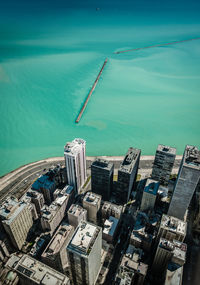 High angle view of buildings by sea against sky