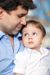 Close-up of cute son looking at father