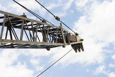 Low angle view of crane against sky