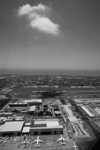 High angle view of buildings by sea against sky