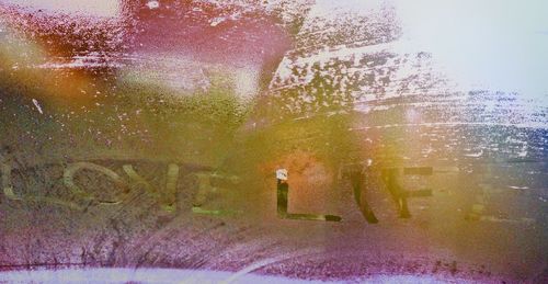 Close-up of water drops on wooden post