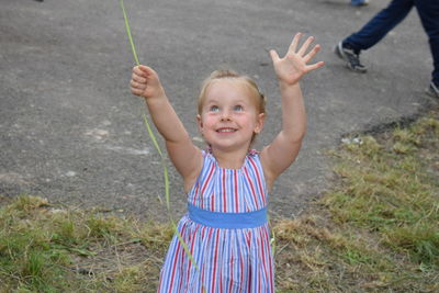 Portrait of smiling girl standing in park