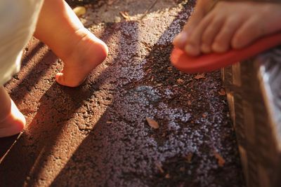 Close-up of hands on sand