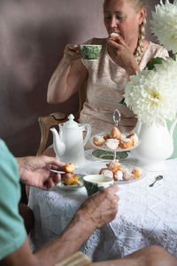 Tea break in the english style,still life with flowers and donuts in the morning