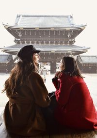 Friends sitting in front of temple