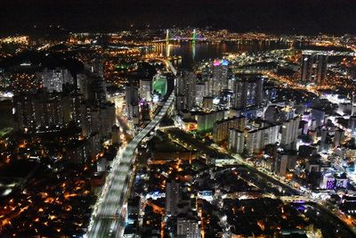 High angle view of city lit up at night