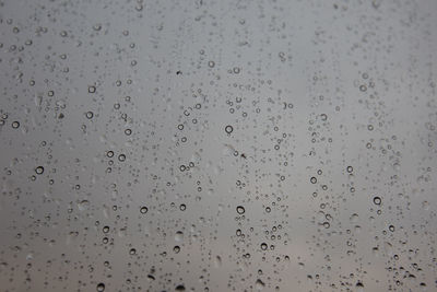 Full frame shot of raindrops on glass window