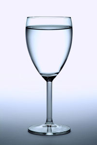 Close-up of wineglass on white background