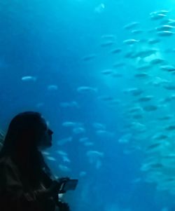 Woman swimming underwater in aquarium