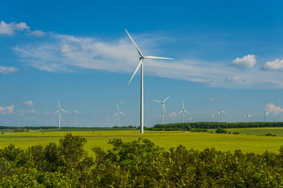 Windmill on field against sky