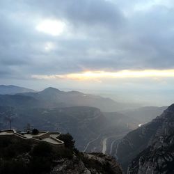 Scenic view of mountains against cloudy sky