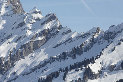 Panoramic view of snow covered mountains against sky