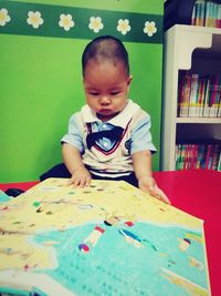 Boy on book at home