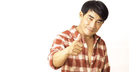 Portrait of smiling man against white background