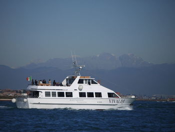 Ship sailing on sea against clear sky