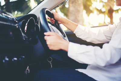 Midsection of man holding mobile phone