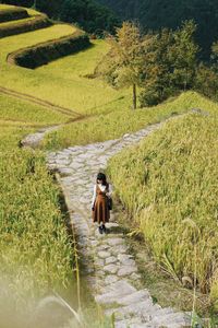 Full length of woman walking on footpath