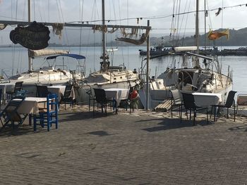 Empty chairs and tables at harbor