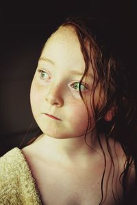 Close-up of girl with green eyes looking away