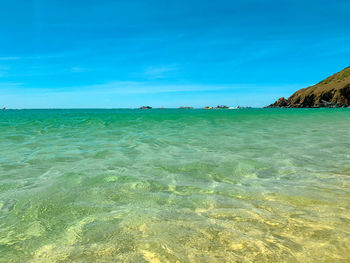 Scenic view of sea against blue sky