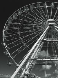 Low angle view of ferris wheel against sky at night